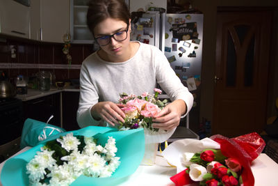 Midsection of woman holding bouquet