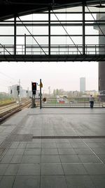 Rear view of man standing on railroad station platform