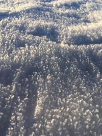 Close-up of snow on water against sky