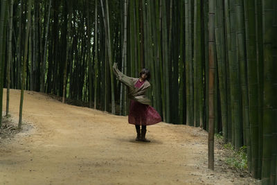 View of a dancing woman in the bamboo forest
