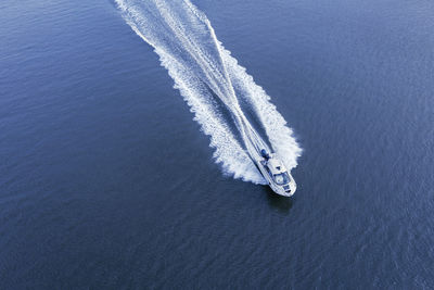 High angle view of vapor trail over sea