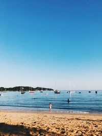 Scenic view of sea against clear blue sky