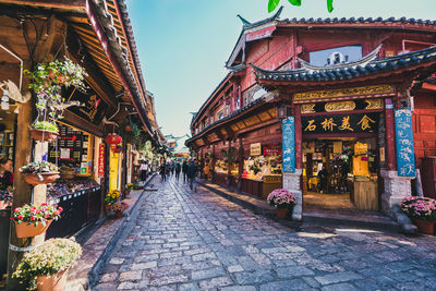 Footpath amidst buildings in city