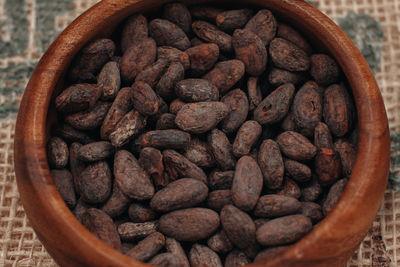 Coco seed preparing to make chocolate. cocoa beans in a wooden plate