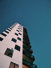 Low angle view of buildings against clear blue sky