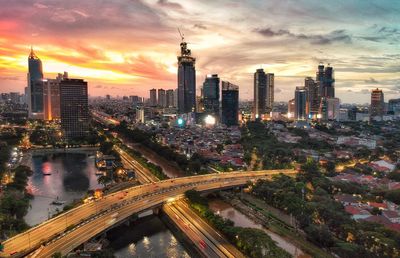 High angle view of illuminated buildings against sky during sunset