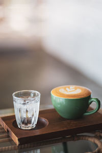 Close-up of coffee with drinking glass on table