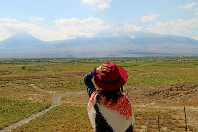 Full length of man standing on field against sky