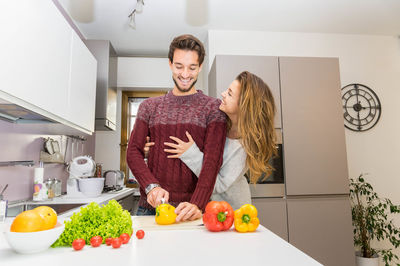 Woman standing by food at home