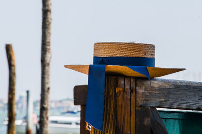 Close-up of wooden post against clear sky