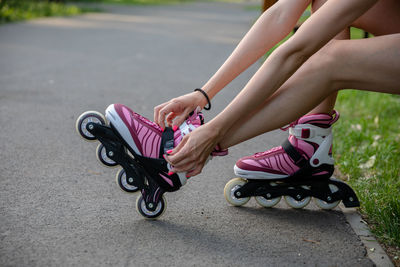 Low section of woman exercising on road