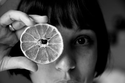 Close-up portrait of woman holding fruit