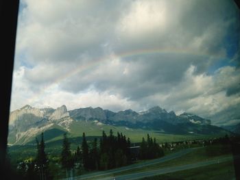 Scenic view of mountains against cloudy sky