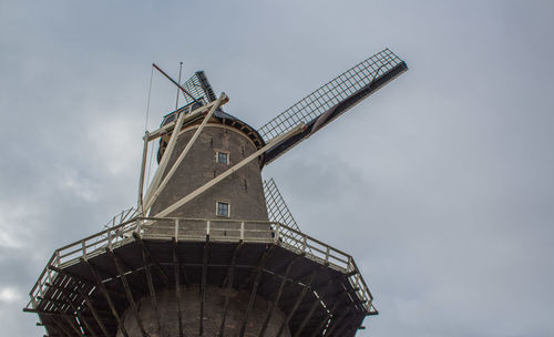 Low angle view of traditional windmill against sky