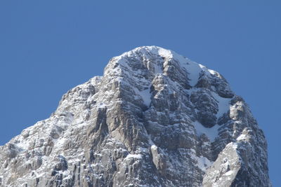 Low angle view of mountains against clear blue sky