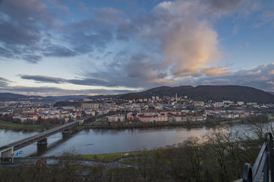 High angle view of townscape by river against sky