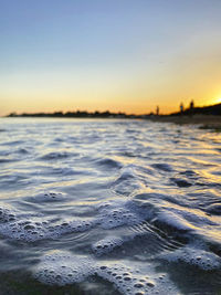 Scenic view of sea against clear sky during sunset