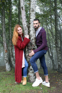 Young couple standing in a forest