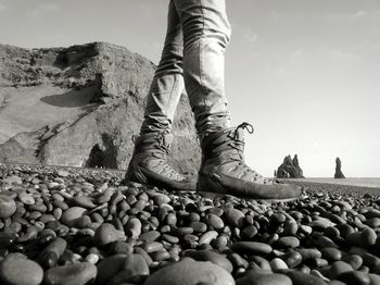 Pebbles at beach against sky