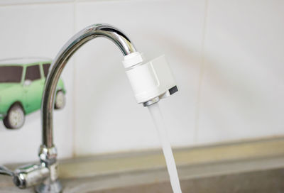 Close-up of faucet in bathroom