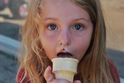 Close-up portrait of a girl eating ice cream