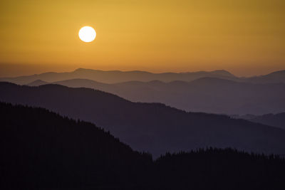 Scenic view of silhouette mountains against sky during sunset