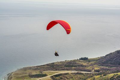 High angle view of skydiver above beach