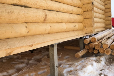 Stack of logs against wall