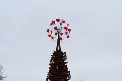 Low angle view of red flowers against sky