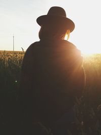 Rear view of silhouette man standing against sky