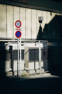 Road sign on street against building