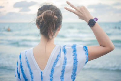 Rear view of woman standing on beach