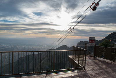 Low angle view of overhead cable car against sky