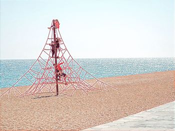 Lifeguard hut on beach against clear sky