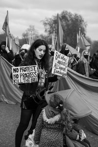 Portrait of friends standing against people