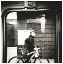 Shadow of man riding bicycle on city street