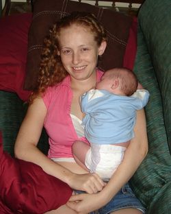 Portrait of happy mother with baby sitting