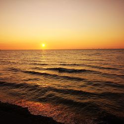 Scenic view of sea against orange sky