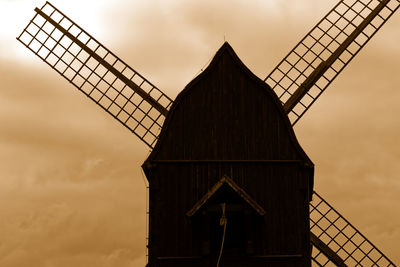 Low angle view of traditional windmill against sky