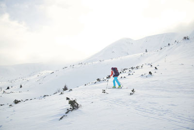 Full length of person on snowcapped mountain against sky