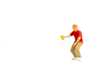 Full length of man holding toy against white background