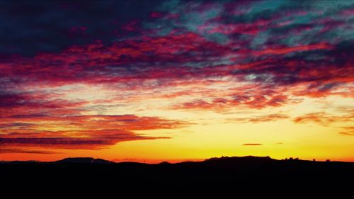 Silhouette of landscape against dramatic sky