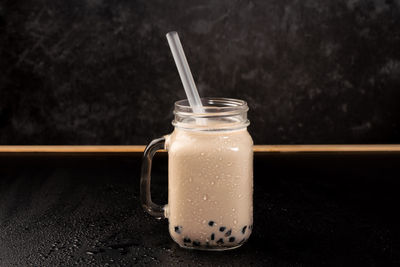 Close-up of drink in glass jar on table