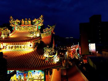 Low angle view of illuminated building at night