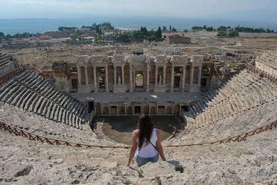 Woman sitting at amphitheater