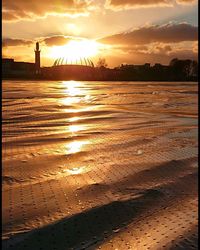 Scenic view of beach against sky during sunset