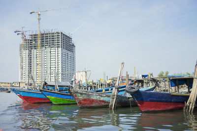 Fishing boats moored in city
