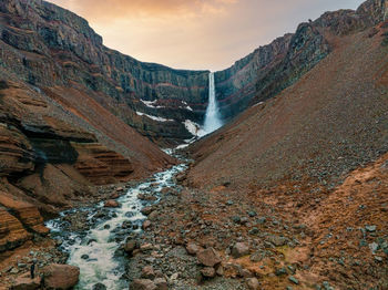 Aerial view on hengifoss waterfall with red stripes sediments in iceland.