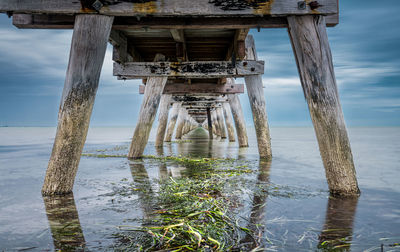 Pier over sea against sky