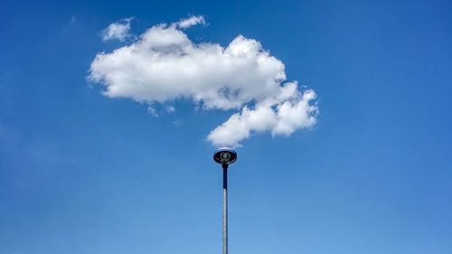 Low angle view of street light against blue sky